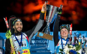 Zwei Skifahrer auf dem Biathlon auf Schalke, die einen Pokal in den Händen halten.