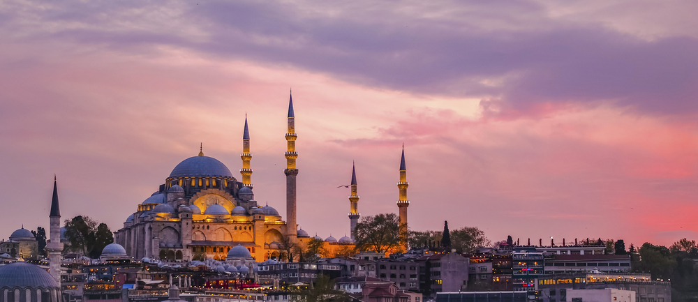 Sultan-Ahmed-Moschee in Istanbul bei Sonnenuntergang mit Kuppeln und Minaretten vor einem rosa-violetten Abendhimmel
